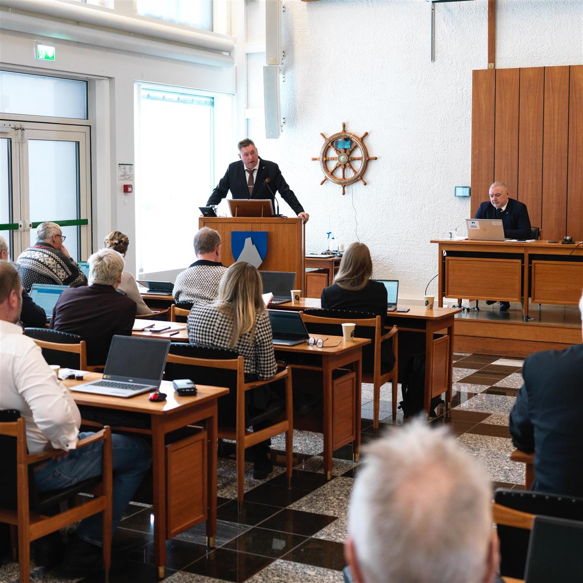 Ordfører Rune Edvardsen på talerstolen i kommunestyrets møte 8. februar 2024. Kommunestyret i forgrunnen, rådmannen til høyre på podiet. - Klikk for stort bilde